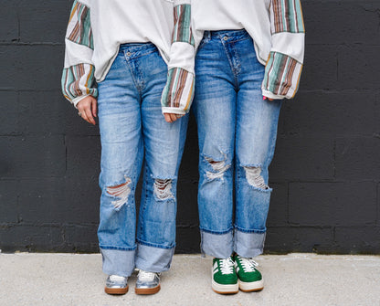 High-Rise Asymmetrical Button Ripped Jeans